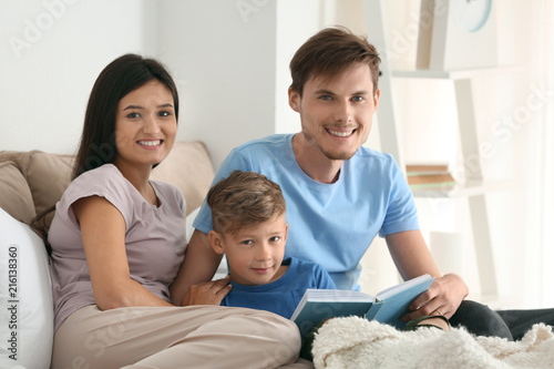 Happy family reading book t...
