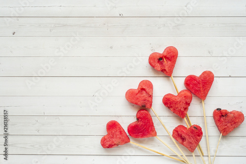 Hearts carved from watermelon on a stick. Concept of Valentine's day Copy space