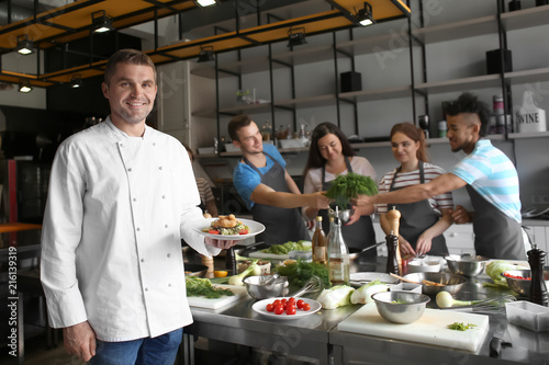 Handsome male chef holding ...
