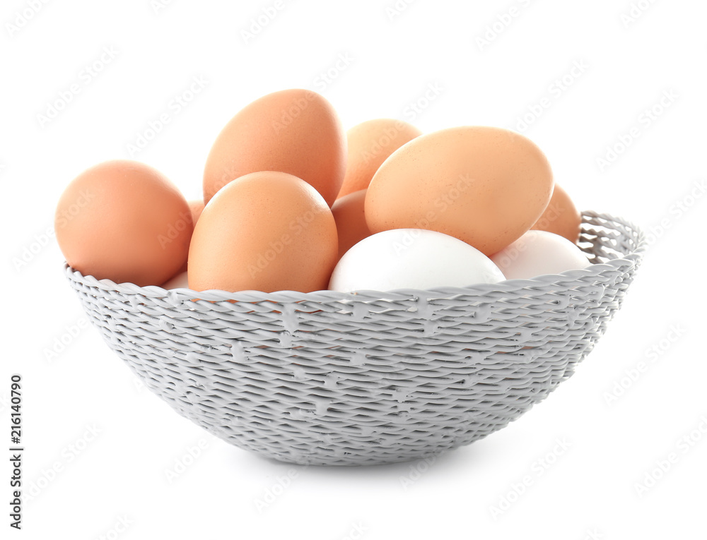 Wicker bowl with chicken eggs on white background Wicker bowl with chicken eggs on white background