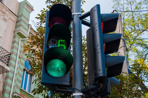 New modern traffic light in the city with a timer showing the seconds remaining. Street background. Concept of road safety photo