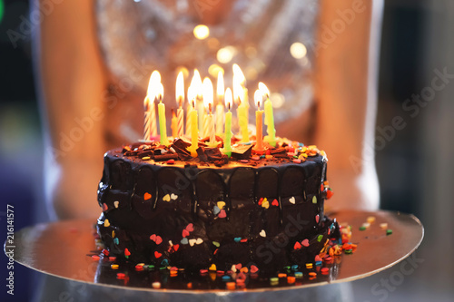 Fotografie Young woman with birthday cake, closeup