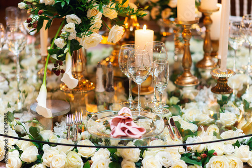 Sparkling glassware stands on table prepared for elegant wedding