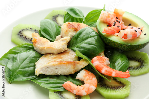 Salad with ripe avocado on plate, closeup