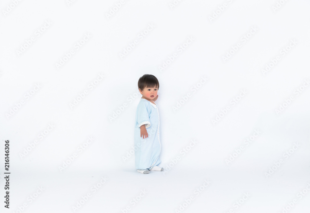 Infant child baby girl kid toddler in diaper make first steps isolated on a white background Infant child baby girl kid toddler in diaper make first steps isolated on a white background