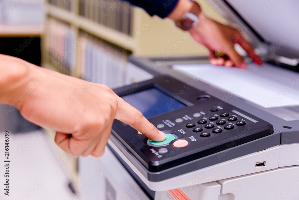 Bussiness man Hand press button on panel of printer, printer scanner laser office copy machine supplies start concept. Bussiness man Hand press button on panel of printer, printer scanner laser office copy machine supplies start concept.