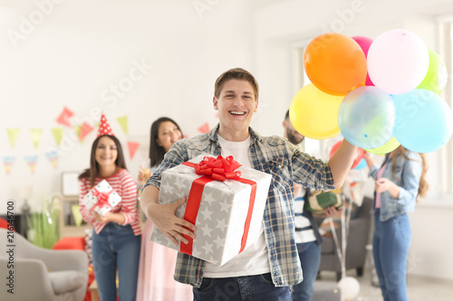 Young man with gift box and...
