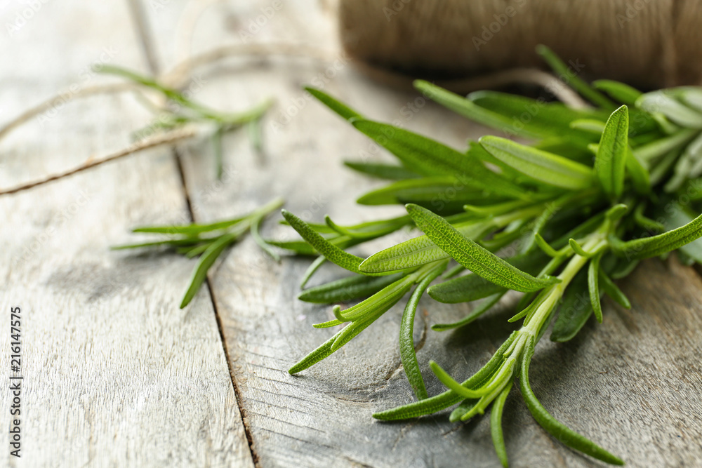 Fresh rosemary on wooden background, closeup Fresh rosemary on wooden background, closeup