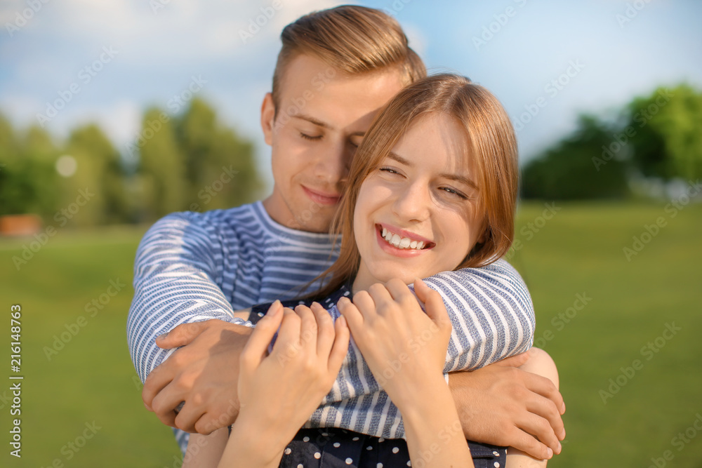 Young couple resting in park on sunny day Young couple resting in park on sunny day