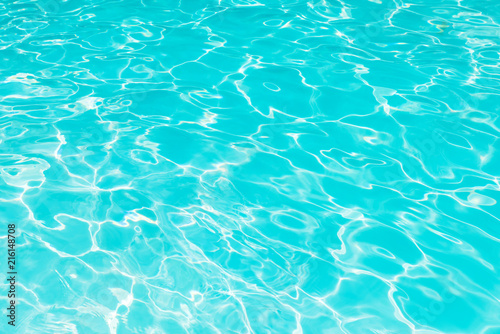 Abstract of blue water surface in swimming pool, Ripple wave in pool with sun reflections