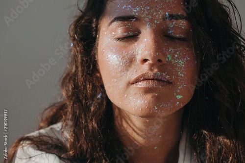 Portrait of a beautiful woman covered in glitter photo