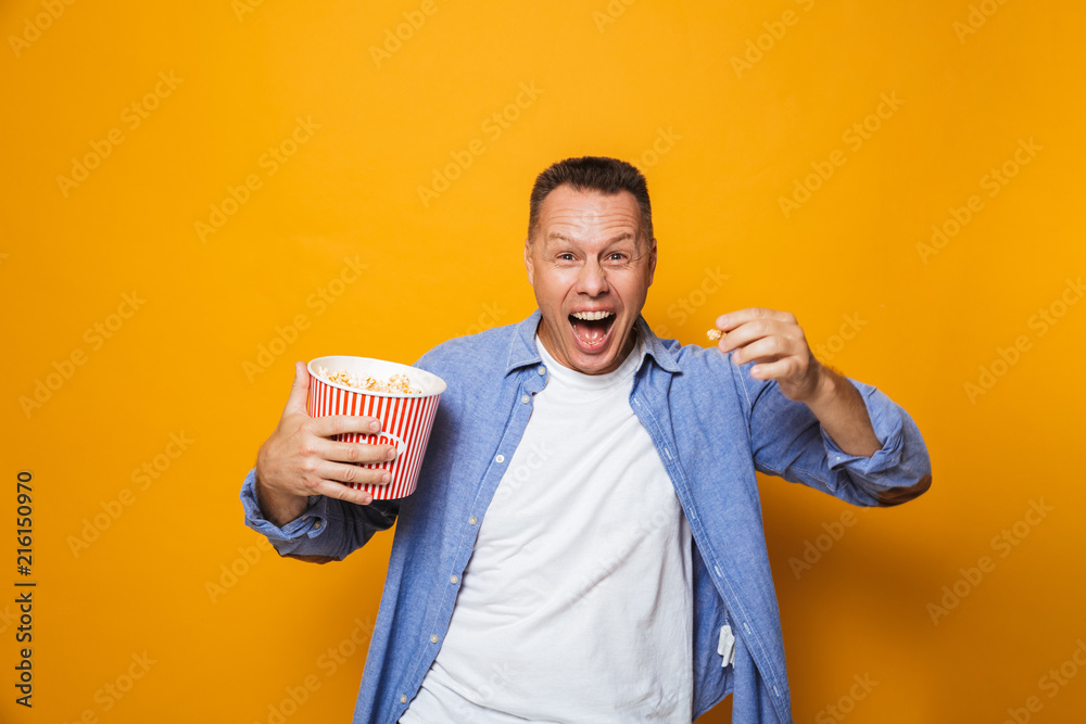 Screaming man eating pop corn watch film looking camera. Screaming man eating pop corn watch film looking camera.