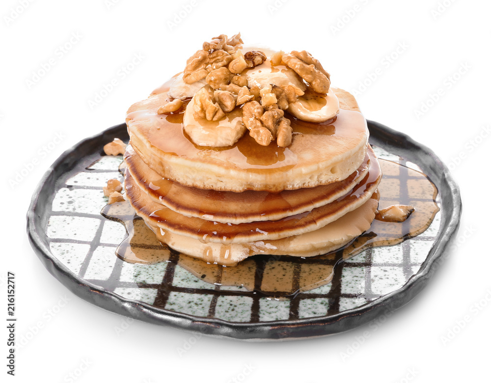 Plate with tasty pancakes, walnuts and sliced banana on white background Plate with tasty pancakes, walnuts and sliced banana on white background