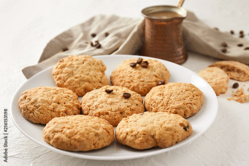 Plate with sweet cookies and jezve of aromatic coffee on table Plate with sweet cookies and jezve of aromatic coffee on table