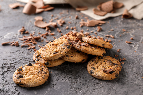 Sweet tasty cookies with chocolate chips on grey textured background