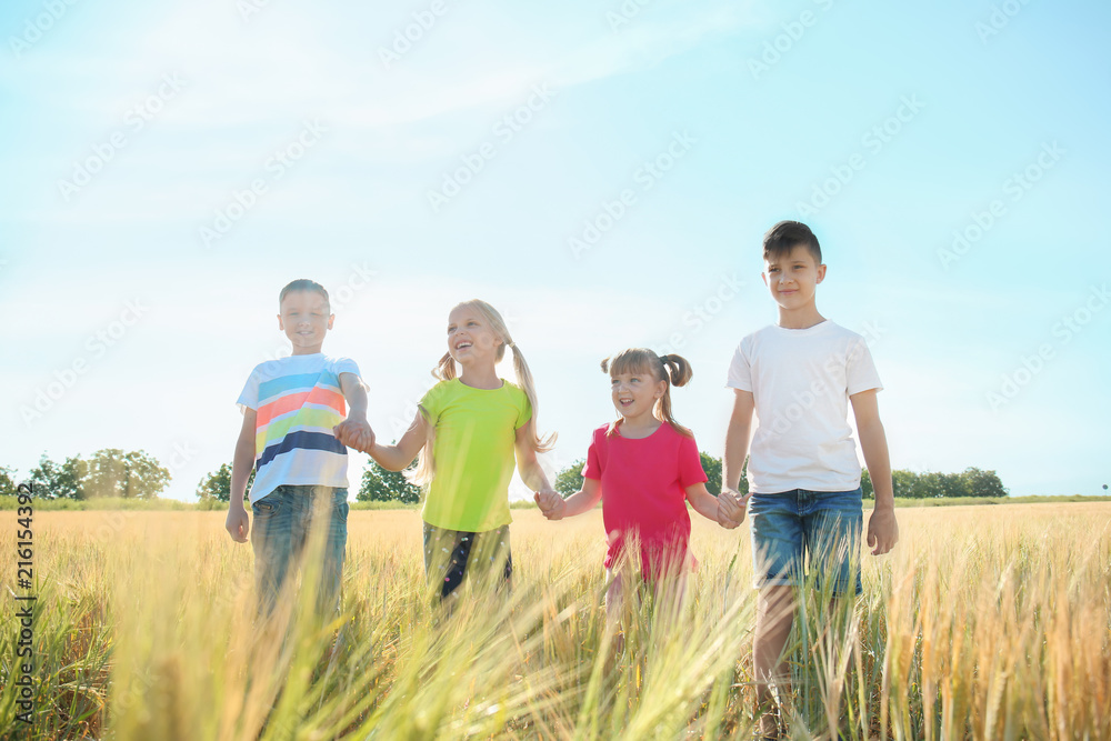 Cute little children holding hands in wheat field on sunny day - obrazy, fototapety, plakaty 