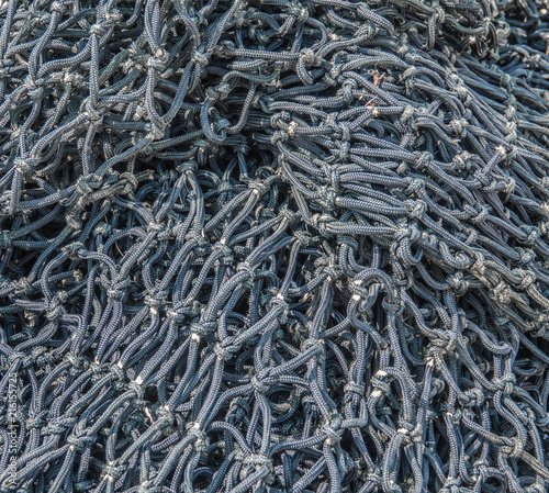 Black fishing net closeup on the quay photo