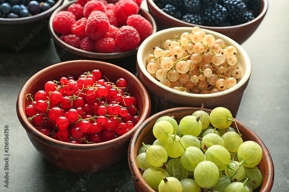 Bowls with various ripe berries on table Bowls with various ripe berries on table