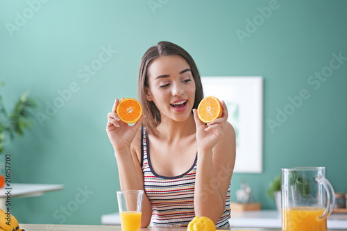 Young woman with halves of ...