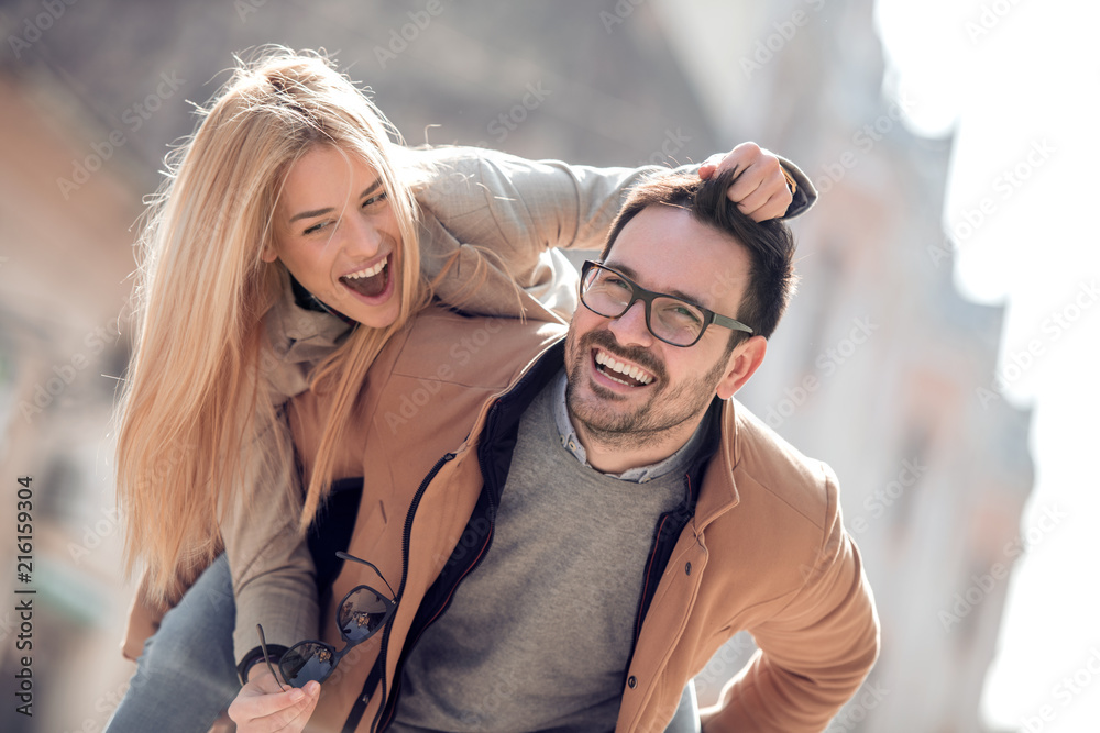 Happy couple smiling and hugging outdoor