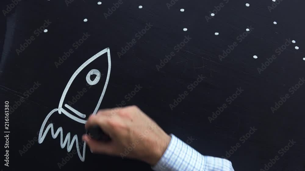 Space rocket with planets and stars doodle drawing on chalkboard, back to school concept