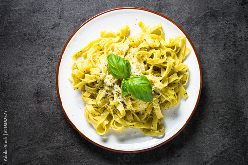 Tagliatelle pasta with pesto sauce and parmesan. photo