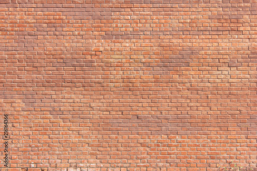 Brick Wall Old Weathered Orange Stone Texture Background. Grunge Abstract Brick Stones Pattern, Colorful Dirty Rough Wall Front Background. Brickwall Material Surface Close Up View with Copy Space.