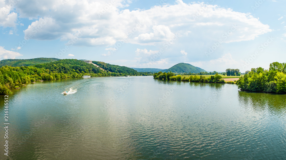 Fototapeta premium Panoramic landscape, Danube River and Walhalla memorial on the hill, tourism and famous places, Donaustauf, Germany, banner 16x9 format
