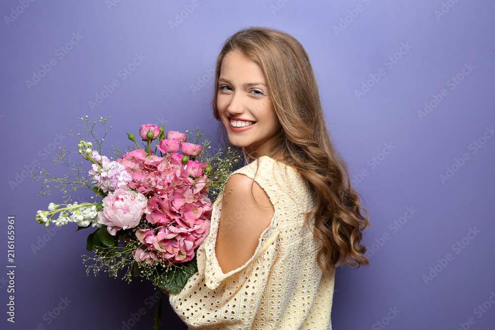 Young woman with beautiful flowers on color background Young woman with beautiful flowers on color background