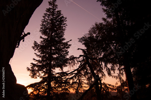 Silhouette of rock climber rock climbing at sunset, Flagstone, Eugene, Oregon, United States