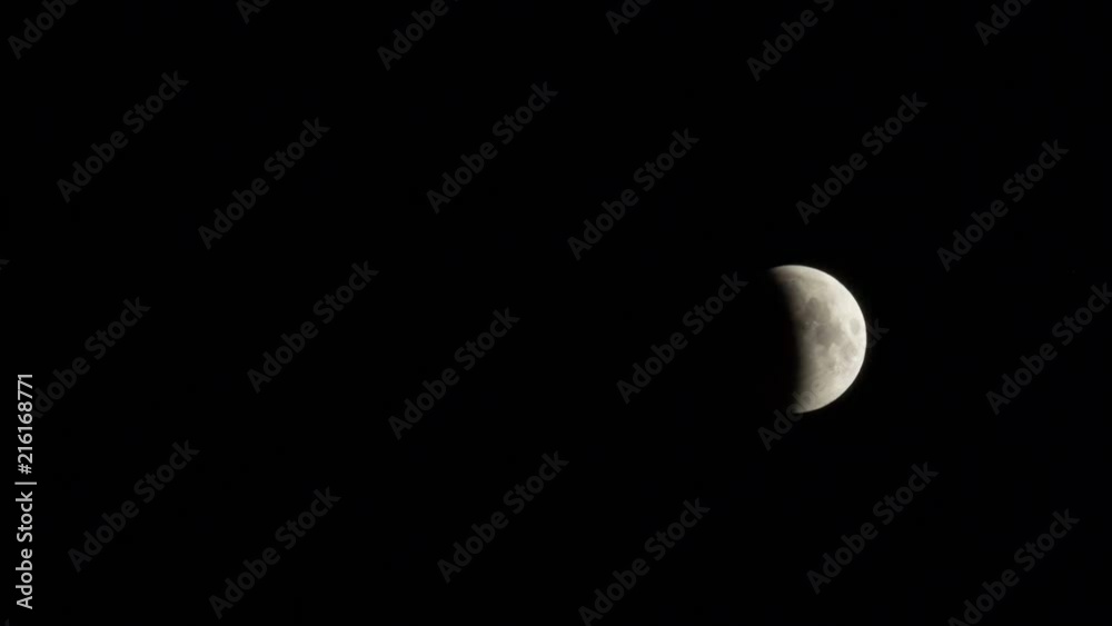 Lunar eclipse July 2018. The shadow of the earth partially overlaps the moon. TimeLapse. Close-up. Lunar eclipse July 2018. The shadow of the earth partially overlaps the moon. TimeLapse. Close-up.