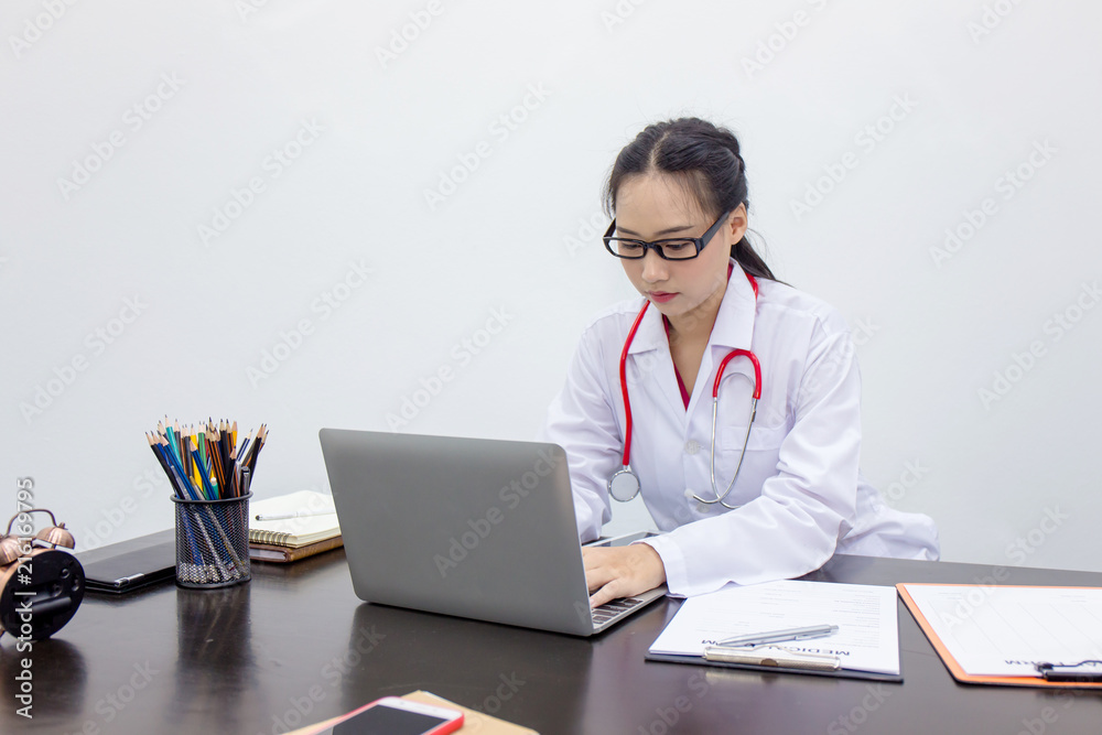 Young doctor woman working on laptop and diagnose a patient illness. Young doctor woman working on laptop and diagnose a patient illness.