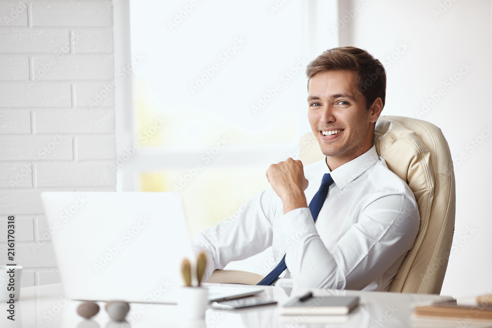 Young handsome businessman working in a modern office Young handsome businessman working in a modern office