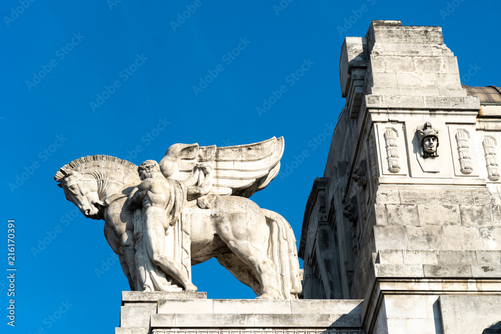 Equestrian statue representing a winged horse and a groom on the Carriage Gallery terrace of the Milan Central Station