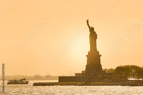 Statue of Liberty silhouette in sunset, New York City, USA.