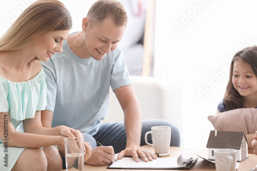 Husband signing a contract ...