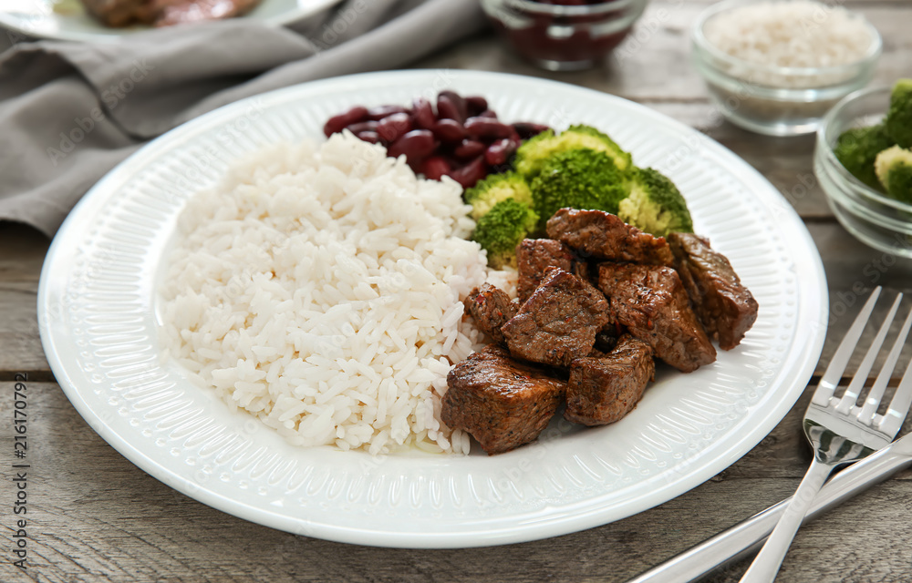 Tasty boiled rice with meat and vegetables on plate Tasty boiled rice with meat and vegetables on plate