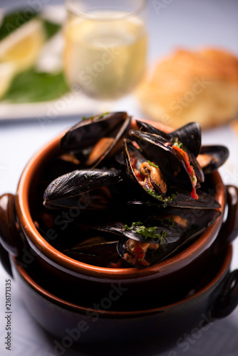 A bowl of delicious moules mariniere for lunch in a seafood restaurant