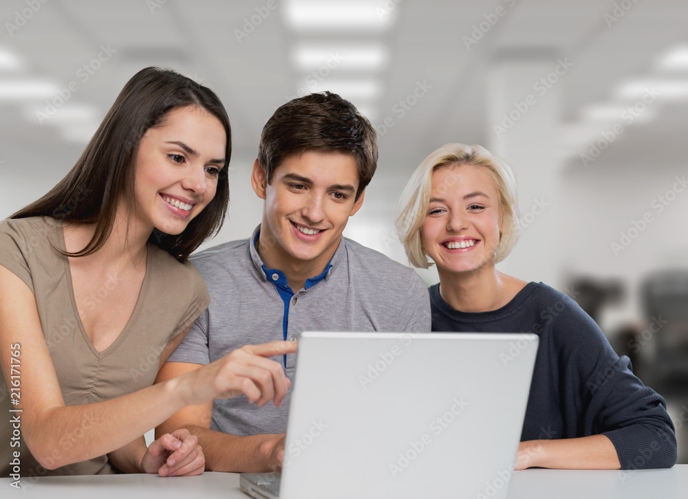 Group of students using a laptop computer