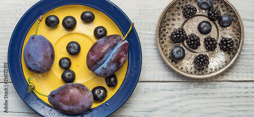 Plums and blueberries in a plate