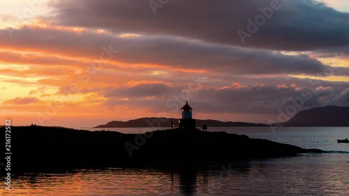 lighthouse with a sunset in the back photo