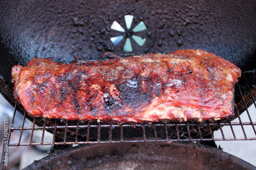 фотографія Rack of dry rub pork ribs on the BBQ grill.