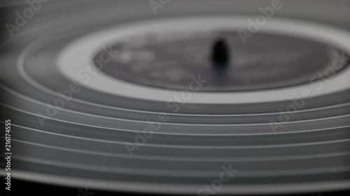 Fragment of a rotating black vinyl record player. Macro. View from above photo