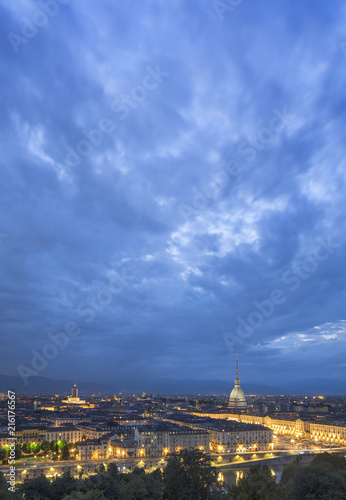night sky with light clouds above night Turin in Italy