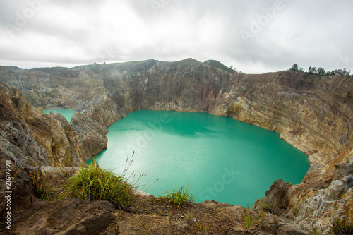 View of Mount Kelimutu and beautiful milky way with Tiwu Ko'o Fai Nuwa Muri and Tiwu Ata Polo  from small town of Moni, Ende,   Flores Island, Indonesia. photo