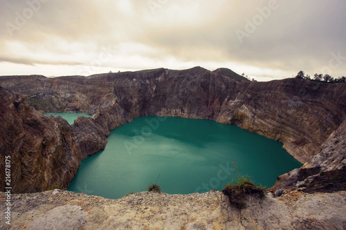 View of Mount Kelimutu and beautiful milky way with Tiwu Ko'o Fai Nuwa Muri and Tiwu Ata Polo  from small town of Moni, Ende,   Flores Island, Indonesia. photo