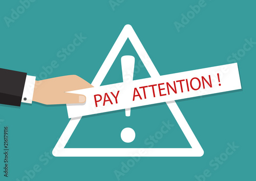 Vector illustration. Hand holding banner with pay attention please.