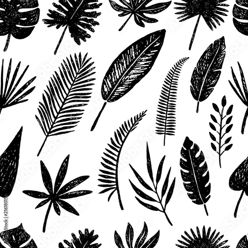 Seamless pattern of hand drawn tropical leaves and flowers.Vector illustration. © ninafedorova