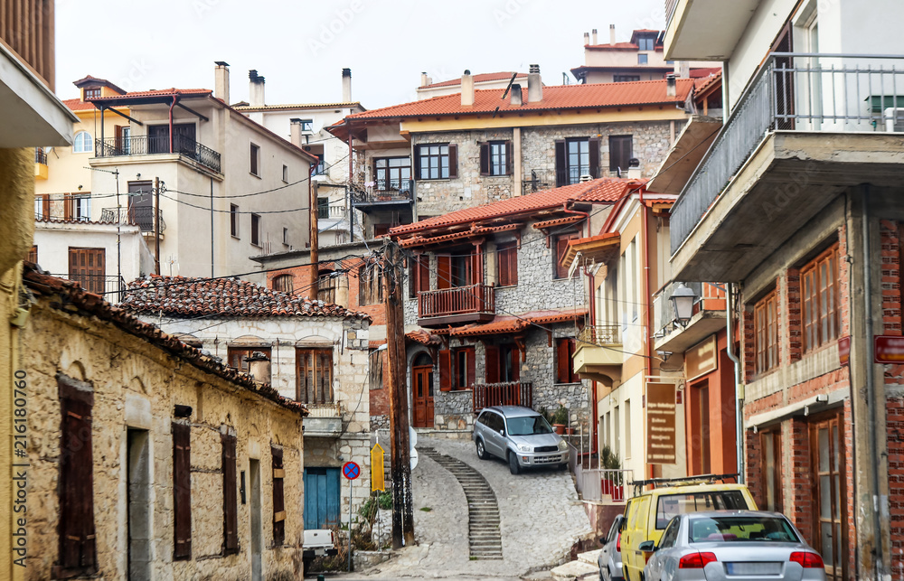 A view of buildings and alleyways and a tangle of electric lines in the mountain town of Delphi Greece