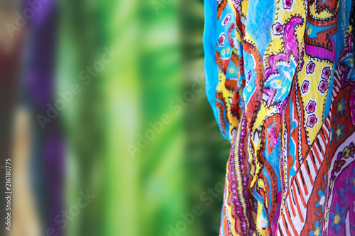 Background with colorful scarf to one side and the rest of the image colorfully blurred - selective focus - room for copy